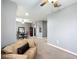 This bright, airy living room features neutral walls, a ceiling fan, and seamless flow into the adjacent dining area at 4041 Byrds Crossing Dr, Lakeland, FL 33812