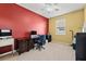 Comfortable office with bold accent wall, ceiling fan, and neutral carpet at 4041 Byrds Crossing Dr, Lakeland, FL 33812