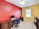 Bright office space with red and yellow walls, a window, and a functional desk setup at 4041 Byrds Crossing Dr, Lakeland, FL 33812