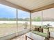 A screened patio with brick floor covering features seating and views of the fenced backyard at 4041 Byrds Crossing Dr, Lakeland, FL 33812