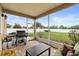 Comfortable screened porch area with outdoor seating, grill, and serene backyard views at 4041 Byrds Crossing Dr, Lakeland, FL 33812