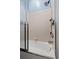 Enclosed shower and tub with tile surround and sleek chrome fixtures at 4041 Byrds Crossing Dr, Lakeland, FL 33812