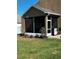 Exterior view of enclosed sunroom featuring a green lawn and tidy landscaping at 4041 Byrds Crossing Dr, Lakeland, FL 33812