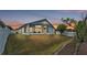 A spacious, fenced backyard features a screened porch and ample green space at 412 Emerald Cove Loop, Lakeland, FL 33813