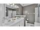 Bathroom with double vanity, shower with glass door, and toilet at 412 Emerald Cove Loop, Lakeland, FL 33813