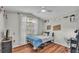 Cozy bedroom with hardwood floors, natural light and a ceiling fan at 412 Emerald Cove Loop, Lakeland, FL 33813