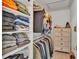 Organized closet with shelving, hanging racks, and a dresser at 412 Emerald Cove Loop, Lakeland, FL 33813