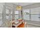 Bright dining area features a wood table, bench seating, and ample natural light from the large windows at 412 Emerald Cove Loop, Lakeland, FL 33813