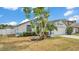 Charming single Gathering home with lush landscaping, blue trim and attached garage at 412 Emerald Cove Loop, Lakeland, FL 33813