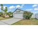 Charming single-story home with well-manicured lawn and two car garage at 412 Emerald Cove Loop, Lakeland, FL 33813