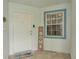 Inviting front porch featuring a tile floor and a decorative 