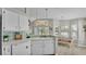Kitchen area with white cabinetry, backsplash, and an adjacent dining area at 412 Emerald Cove Loop, Lakeland, FL 33813