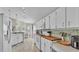 Well-lit kitchen with white cabinets, butcher block countertops, and stainless steel appliances at 412 Emerald Cove Loop, Lakeland, FL 33813