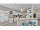 Kitchen featuring white cabinets, a breakfast bar with seating, and modern pendant lighting at 412 Emerald Cove Loop, Lakeland, FL 33813