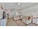 Spacious living room with vaulted ceiling, large sectional sofa, and stylish decor at 412 Emerald Cove Loop, Lakeland, FL 33813