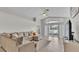 Bright living room with vaulted ceiling, neutral walls, tile flooring, and sliding glass doors at 412 Emerald Cove Loop, Lakeland, FL 33813