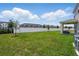 Expansive backyard with lush green lawn, privacy fence, and covered patio, perfect for outdoor living at 4122 Conjunction Way, Apopka, FL 32712