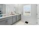 Bright bathroom with double vanity, ample counter space, and a large window at 4122 Conjunction Way, Apopka, FL 32712