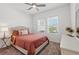 Cozy bedroom featuring a comfortable bed, neutral decor, and lots of natural light from the windows at 4122 Conjunction Way, Apopka, FL 32712