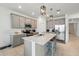 Modern kitchen with an island, gray cabinets, and stainless steel appliances at 4122 Conjunction Way, Apopka, FL 32712