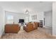Spacious living room featuring neutral tones, plush carpeting, and stylish light fixtures at 4122 Conjunction Way, Apopka, FL 32712