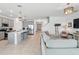 Bright open living space featuring modern kitchen with stainless appliances flowing into a comfortable living area at 4122 Conjunction Way, Apopka, FL 32712