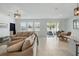Inviting living and dining area with tile floors, comfortable seating, and a view to the outdoor patio at 4122 Conjunction Way, Apopka, FL 32712