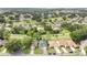Aerial view of neighborhood with lush green landscaping and community golf course at 432 Sandestin Dr, Winter Haven, FL 33884