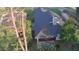 Aerial view of home featuring a dark shingled roof, screened porch, landscaping and mature trees at 432 Sandestin Dr, Winter Haven, FL 33884