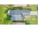 Aerial view of home showcasing roof, driveway, and well-manicured landscaping at 432 Sandestin Dr, Winter Haven, FL 33884
