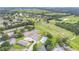 Stunning aerial view of a community offering golf course, tennis courts, and swimming pool amenities at 432 Sandestin Dr, Winter Haven, FL 33884