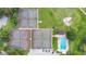 Overhead view showcasing tennis courts and a refreshing community swimming pool with lounge chairs at 432 Sandestin Dr, Winter Haven, FL 33884