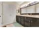 Bathroom with a double sink vanity, granite countertops, and a large mirror at 432 Sandestin Dr, Winter Haven, FL 33884