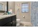 Bathroom with a granite countertop, a large mirror, and decorative starfish artwork at 432 Sandestin Dr, Winter Haven, FL 33884
