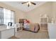 Bedroom with tiled floors, ceiling fan, and well lit with a large window at 432 Sandestin Dr, Winter Haven, FL 33884