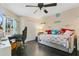 Well-lit second bedroom with dark wood floors, a ceiling fan, and a window at 432 Sandestin Dr, Winter Haven, FL 33884