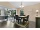 Bright dining area with sliding door to the screened porch and neutral decor at 432 Sandestin Dr, Winter Haven, FL 33884