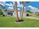 Inviting single Gathering home with a well manicured green lawn and a two-car garage on a sunny day at 432 Sandestin Dr, Winter Haven, FL 33884