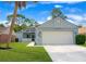 Charming single-Gathering home featuring a two-car garage, well-maintained lawn, and inviting screened porch at 432 Sandestin Dr, Winter Haven, FL 33884