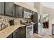 Modern kitchen featuring granite countertops, stainless steel appliances, and dark cabinetry at 432 Sandestin Dr, Winter Haven, FL 33884