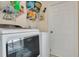 Laundry room with shelving, a door to the outside, a washing machine, and a dryer at 432 Sandestin Dr, Winter Haven, FL 33884