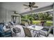 Relax on this enclosed porch with ceiling fans and great views of the landscaped yard at 432 Sandestin Dr, Winter Haven, FL 33884