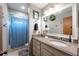 Bathroom featuring a granite countertop vanity, large mirror, and a shower with blue curtain at 4825 Luce Rd, Lakeland, FL 33813