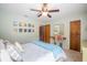 Cozy bedroom with a ceiling fan, light green walls, and wall art for a relaxing ambiance at 4825 Luce Rd, Lakeland, FL 33813