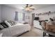 Bedroom with fan, white walls, a dresser, window, and a comfortable bed for cozy living at 4825 Luce Rd, Lakeland, FL 33813