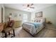 Cozy bedroom with a bed, desk, and ceiling fan at 4825 Luce Rd, Lakeland, FL 33813