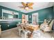 A teal dining room with a large wooden table and view into an adjacent room at 4825 Luce Rd, Lakeland, FL 33813