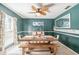 Dining room with teal walls, a modern table and bench, and a tropical-themed ceiling fan at 4825 Luce Rd, Lakeland, FL 33813