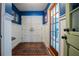 Bright foyer with blue accent wall, white wainscoting, and hardwood floors at 4825 Luce Rd, Lakeland, FL 33813