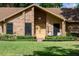 Close-up of the brick house facade, highlighting the front door and well-kept lawn at 4825 Luce Rd, Lakeland, FL 33813
